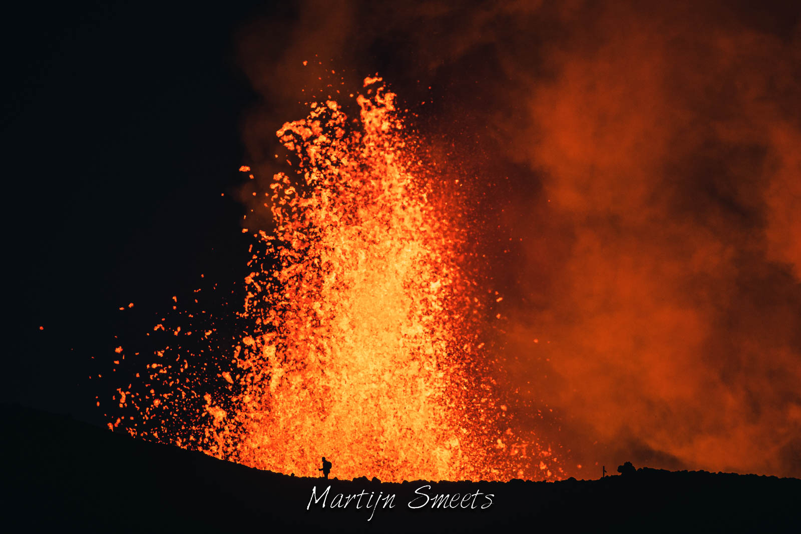 Spectator in front of a lava fountain of the Fagradalsfjall volcano in Iceland