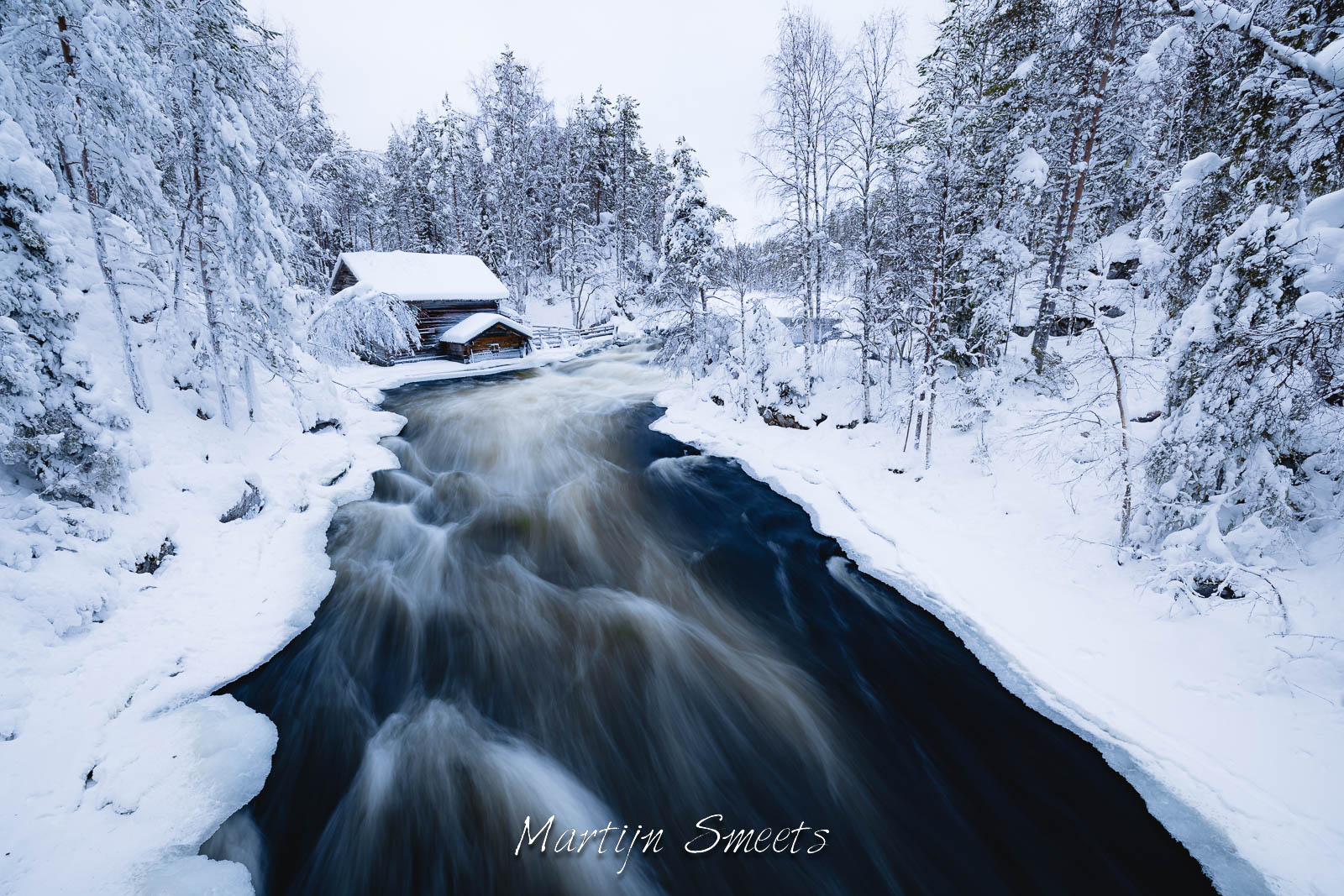The river at the Myllykoski day trip hut in winter at Oulanka National Park in Finland